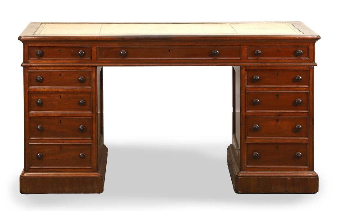 A twin pedestal mahogany partners desk, early 20th century,: A twin pedestal mahogany partners desk, early 20th century, with an arrangement of eleven drawers and opposing cupboard doors on the base, with beige toile leather inlay to the top 147cm wide, 63cm de