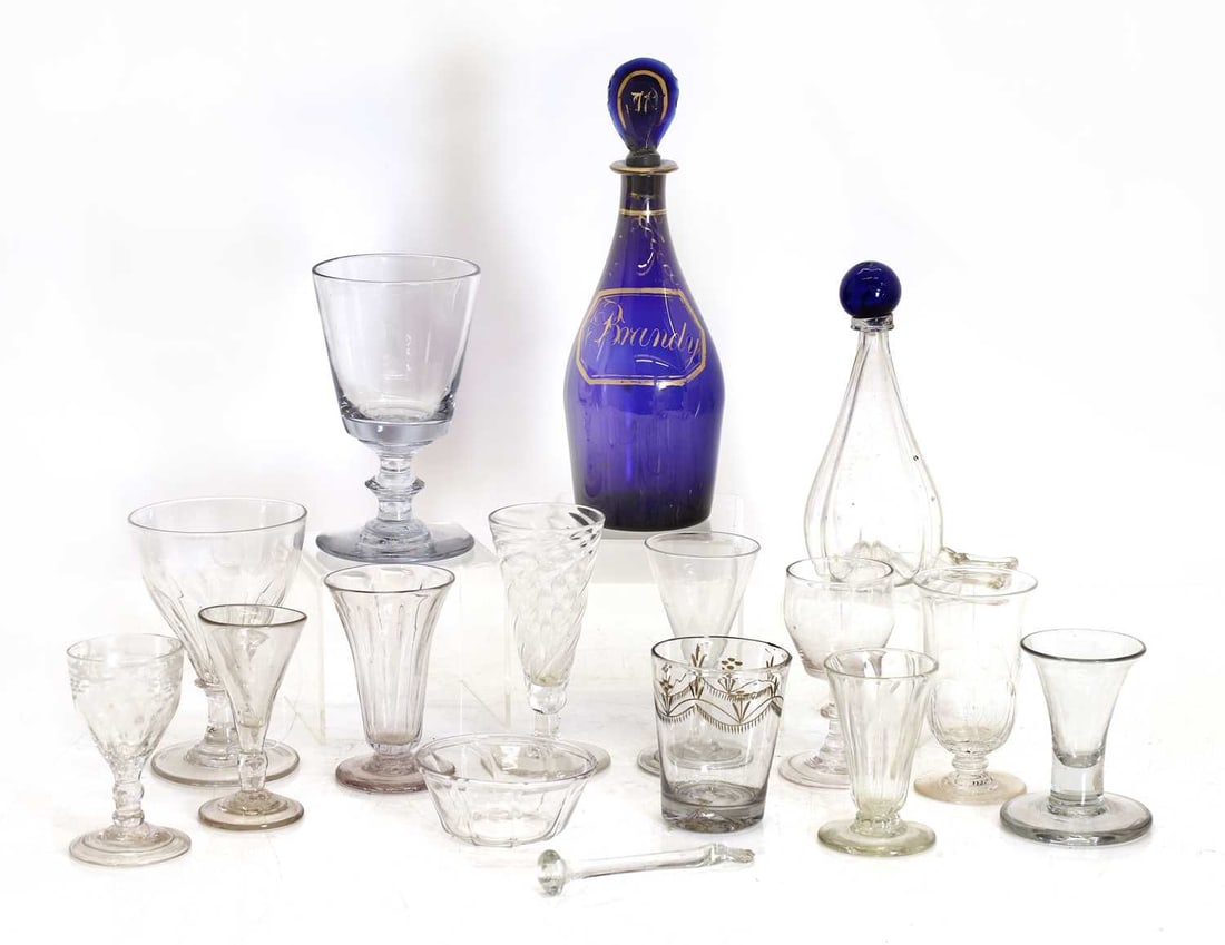 A collection of Georgian and later table glass, 18th century and later,: A collection of Georgian and later table glass, 18th century and later, to include a firing glass, syllabub glasses, and a Regency blue decanter, labeled 'Burgundy' Decanter, 25cm high (qty.)