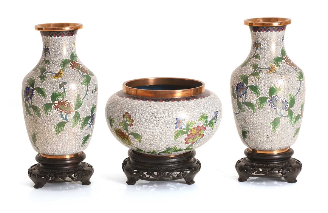 A group of three cloisonné vases, 20th century,: A group of three cloisonné vases, 20th century, each decorated with scrolling foliage on a white ground, with a hardwood stand vase 14.5cm diameter 6