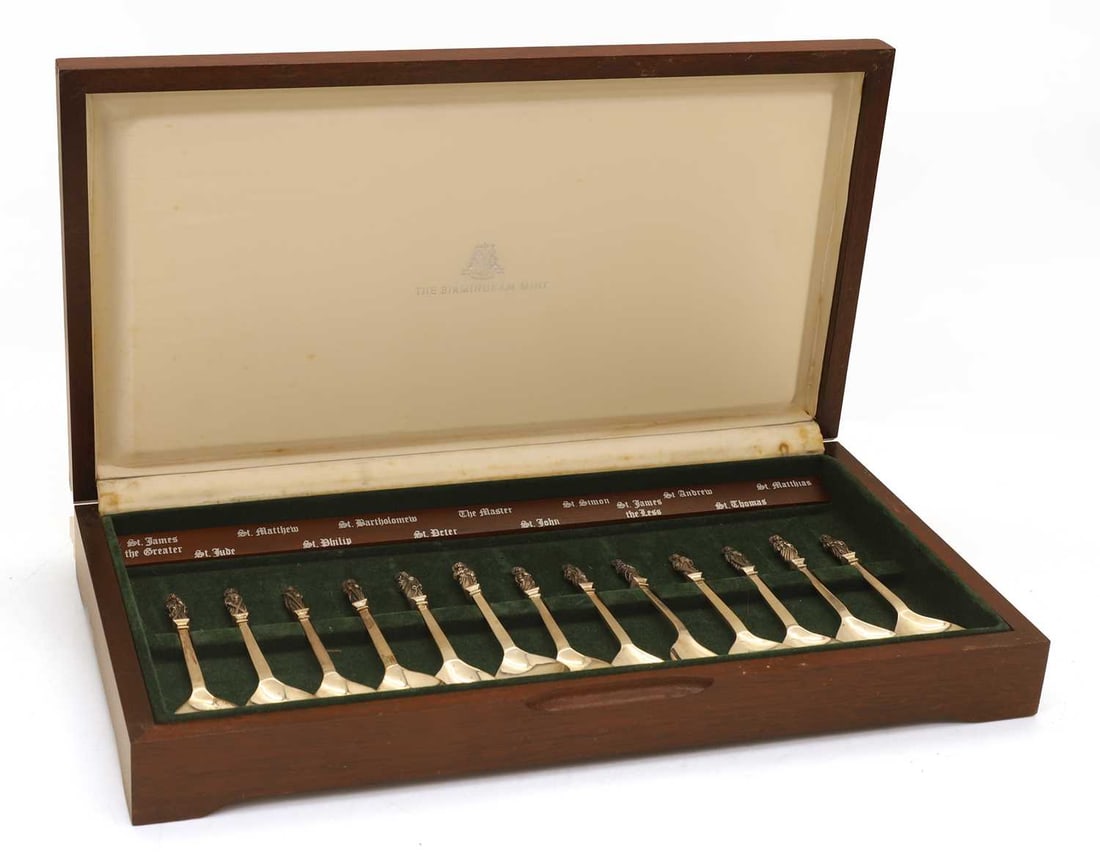 A cased set of apostle spoons,: A cased set of apostle spoons, by The Birmingham Mint Ltd, Birmingham, 1976, all with apostle on the surmount, cased with the names of each apostle Spoon, 14.5cm long, 14.1ozt (qty.)