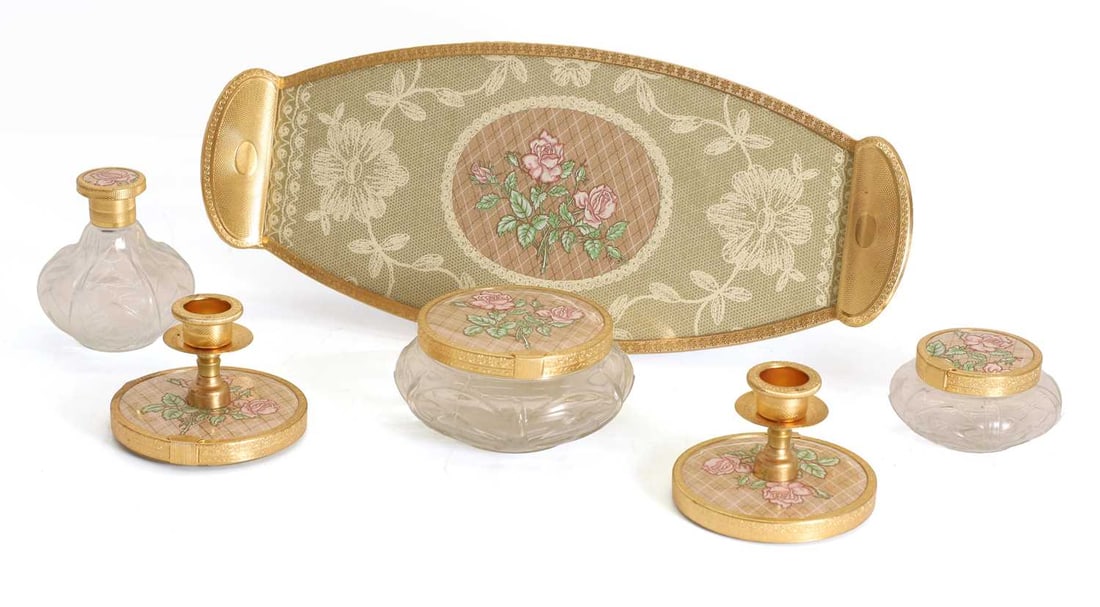 A boxed dressing table set, 20th century,: A boxed dressing table set, 20th century, to include a handled glass tray, two lidded glass pots, a moulded glass bottle and two candle sconces, all detailed with similar floral motifs, together