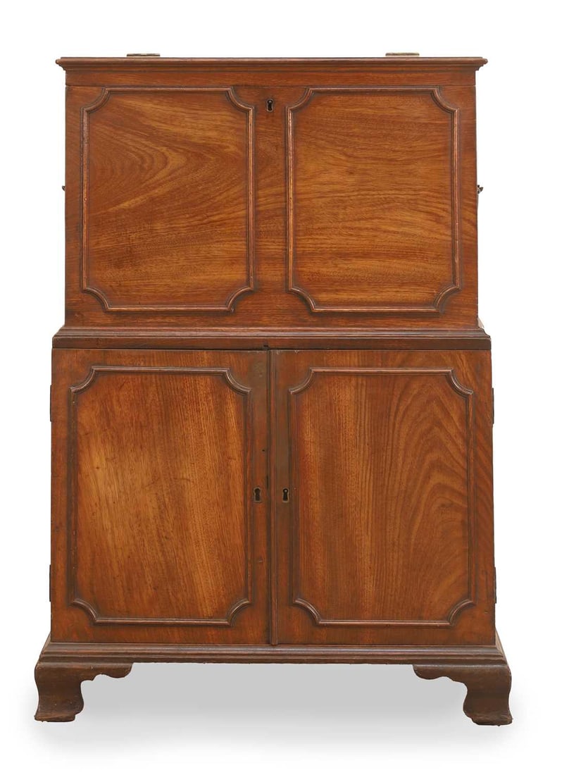 A George III mahogany cellarette on cupboard, early 19th century,: A George III mahogany cellarette on cupboard, early 19th century, of small proportions, with a hinged top, over a cupboard enclosing a shelf, with moulded panels, the upper section with carrying