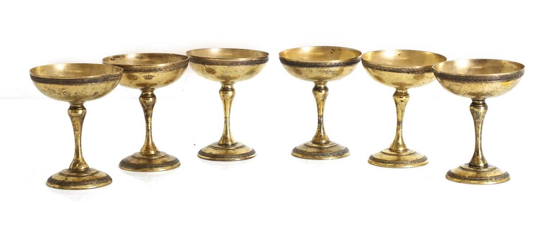 A set of six silver coupe glasses,: A set of six silver coupe glasses, stamped '900' and 'TORINO', of traditional form with floral banding to the base and rim, with crown crest to the exterior 9.5cm wide, 12cm high, 23.7ozt 6