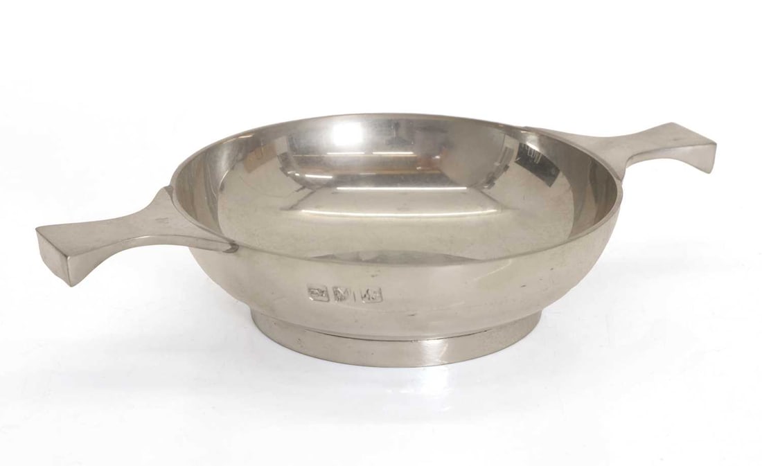 A quaich,: A quaich, with twin handles, inscribed 'ROGER ABRAHAM From Albany School in appreciation of all your help', with stamped marks to the side, white metal 21cm wide, 3.7cm high