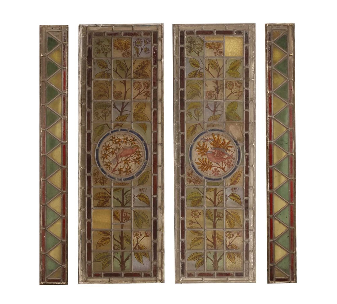 A pair of Arts and Crafts stained glass panels,: A pair of Arts and Crafts stained glass panels, with a central bird decorated roundel encompassed amongst a naturalistic setting, together with two side panels The larger panels, 35cm wide, 108cm