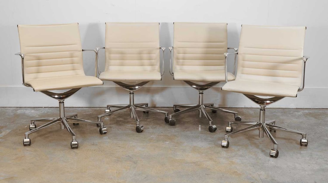 Four ICF 'Executive' cream leather office chairs, of recent manufacture,: Four ICF 'Executive' cream leather office chairs, of recent manufacture, in the style of Charles and Ray Eames, each with channeled back and seat above chromed arms and a four-point revolving base