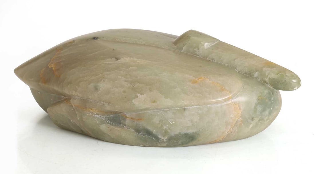 A stone crane,: A stone crane, carved from light green stone, possibly marble, modelled as a crane nesting 31cm wide, 18cm deep, 10cm high Condition Report: Some marsk and scratches to the surface. Natural flaws in