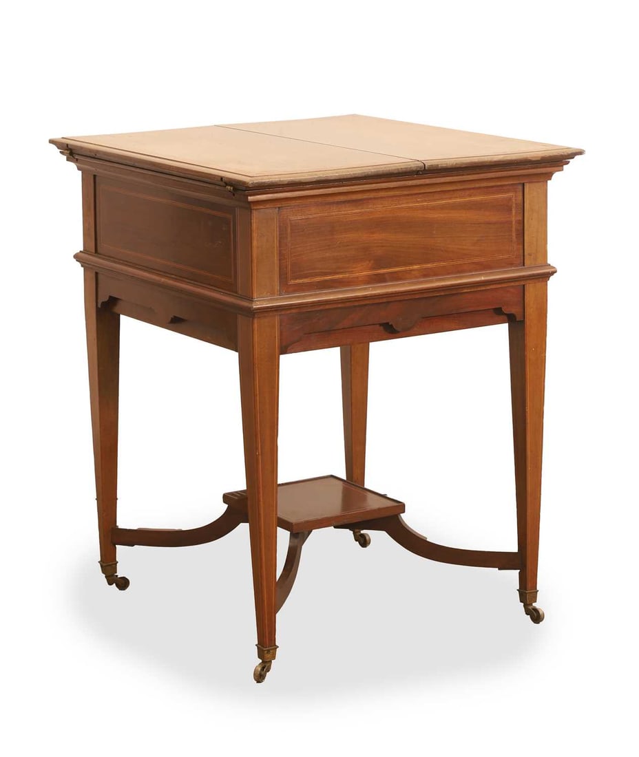 An Edwardian mahogany 'Surprise' action drinks table/cabinet, circa early 20th century,: An Edwardian mahogany 'Surprise' action drinks table/cabinet, circa early 20th century, the hinged top revealing a tray, rising on a mechanism, with an undertier, raised on castors 61cm wide, 58cm