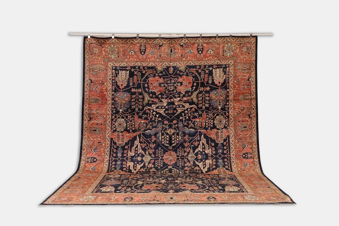 A wool carpet of Persian Heriz design, of recent manufacture,: A wool carpet of Persian Heriz design, of recent manufacture, woven with scrolling foliate motifs to a blue ground (413 x 294cm) Condition Report: The actual colour of the lot may vary from images in 