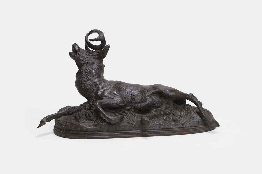 After Paul-Édouard Delabrièrre, late 19th/early 20th century,: After Paul-Édouard Delabrièrre, late 19th/early 20th century, a bronze figure of a recumbent stag on a naturalistic base, signed 'E. Delabrierre' (41cm wide, 14cm deep, 22cm high) Condition 