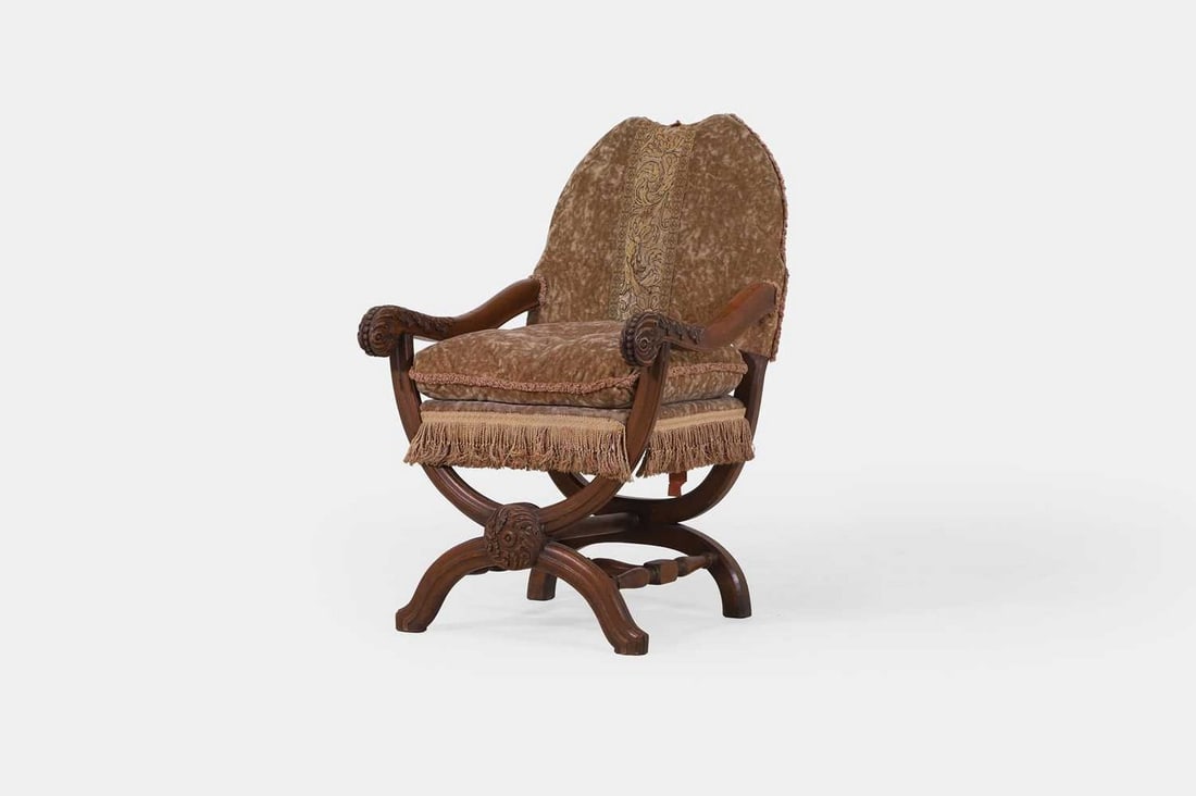 A 17th-century-style oak 'X'-framed armchair, manufactured in 1931, (1 of 3)