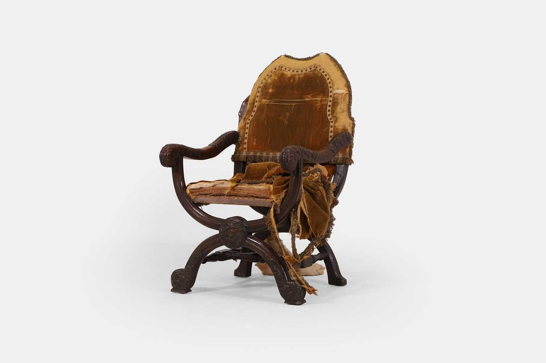 An 'X'-framed walnut armchair, 19th century with earlier additions, (1 of 3)
