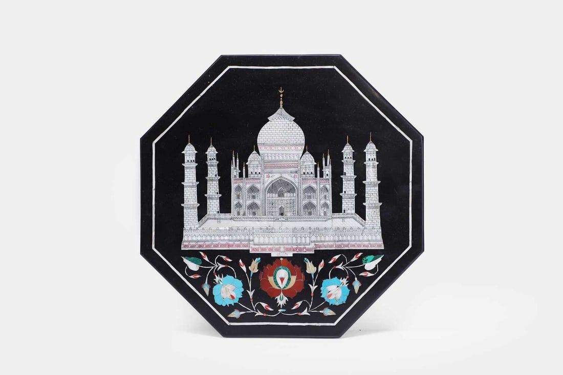 A pietra dura and mother-of-pearl plaque, 20th century, Indian,: A pietra dura and mother-of-pearl plaque, 20th century, Indian, of octagonal form, inlaid with the front elevation of the Taj Mahal, over a panel of flower heads and scrolling foliate tendrils (31cm d