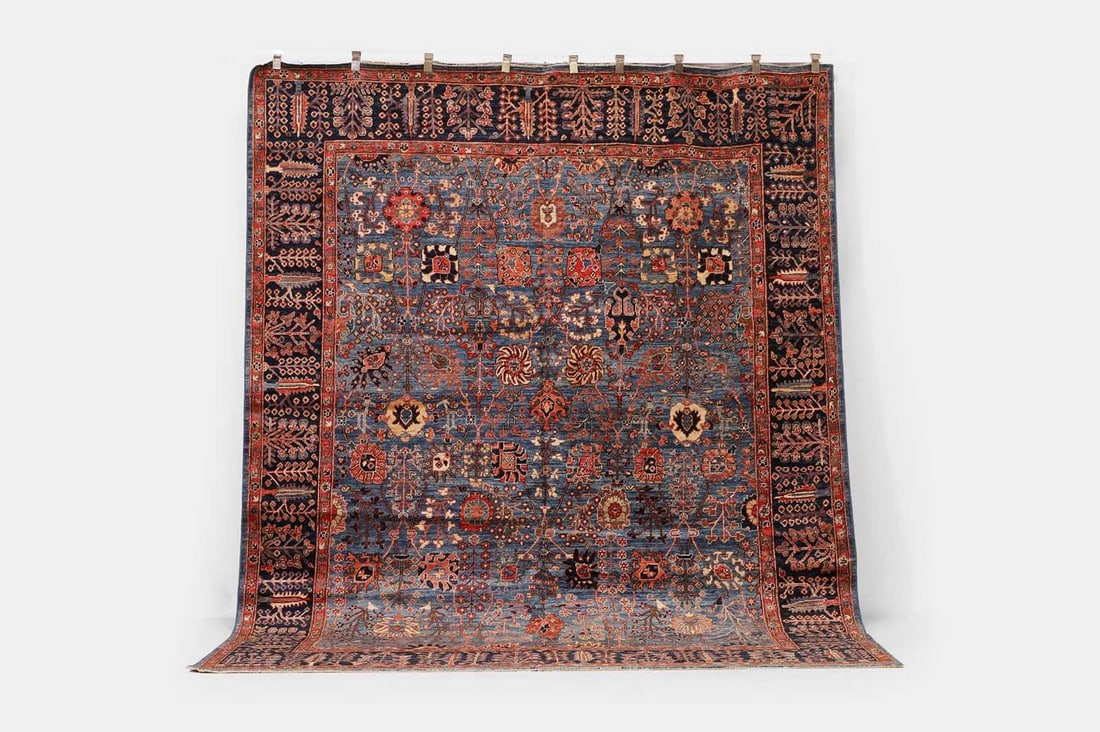 A wool carpet of antique North-West Persian design, of recent manufacture,: A wool carpet of antique North-West Persian design, of recent manufacture, woven with Shah Abbasi motifs to a blue ground (303 x 244cm) Condition Report: The actual colour of the lot may vary from ima