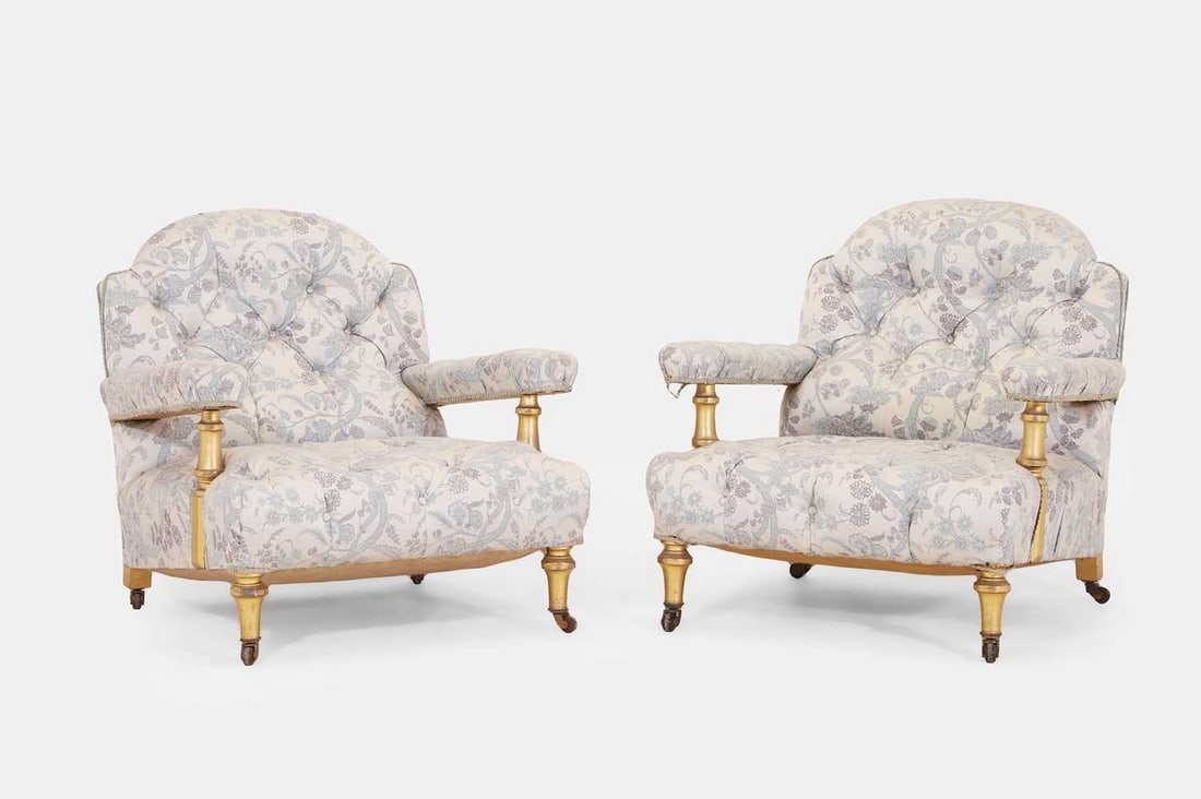 A pair of armchairs, 20th century, in the manner of Howard & Sons, London, (1 of 3)