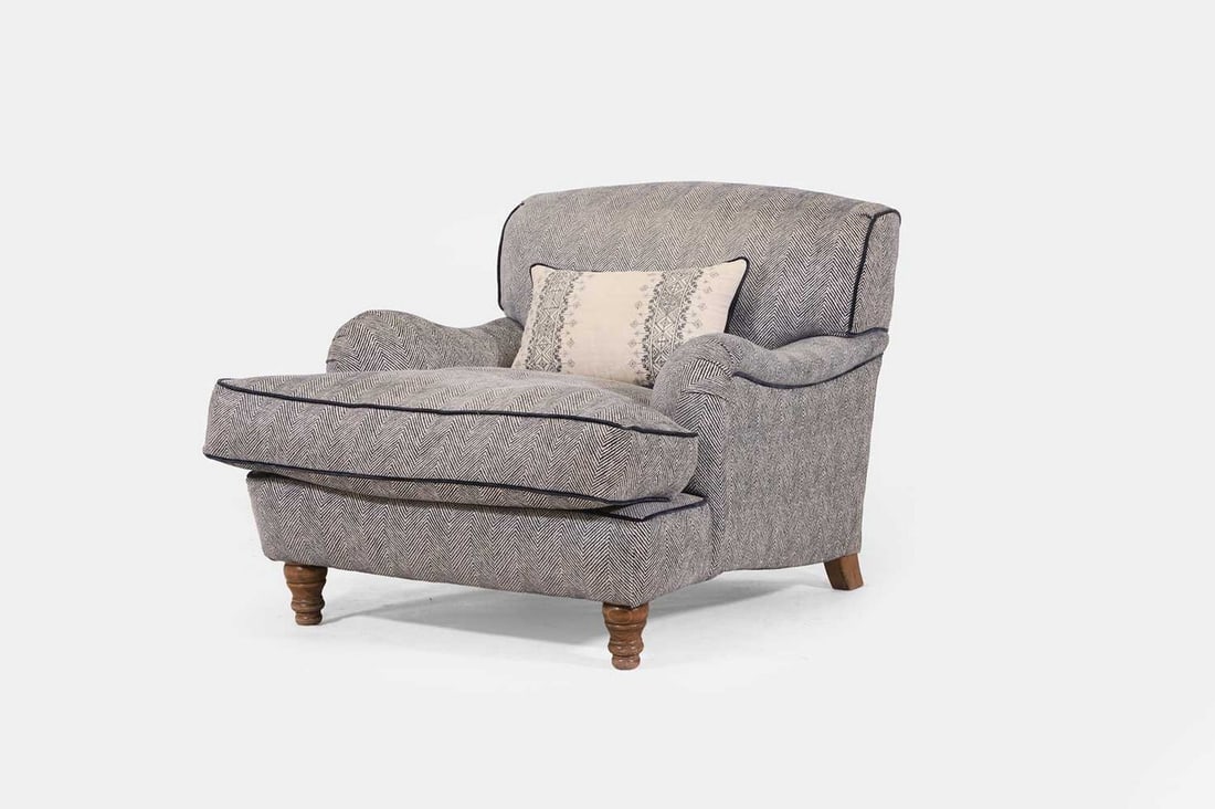 An upholstered armchair in the Howard & Sons style, of recent manufacture,: An upholstered armchair in the Howard & Sons style, of recent manufacture, covered in blue herringbone wool, raised on turned beech front supports (90cm wide, 110cm deep, 80cm high) Condition Report: 