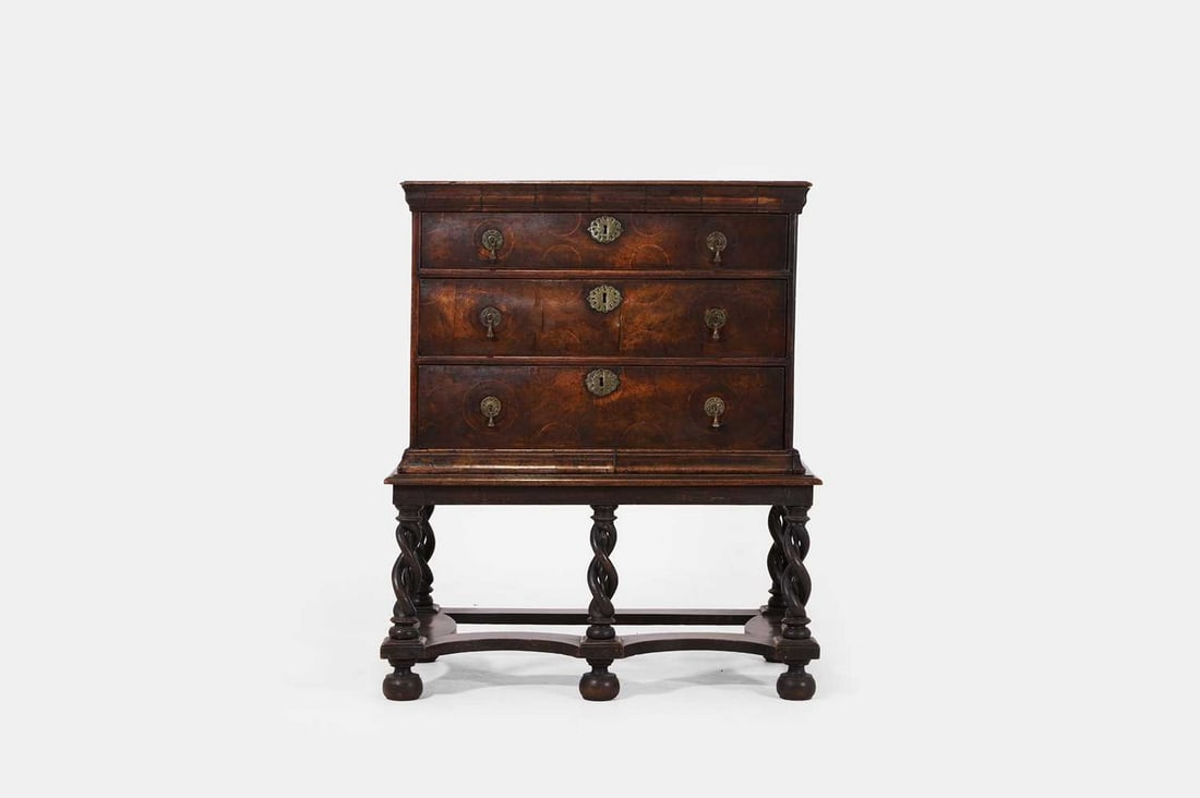 A Charles II walnut and sycamore-inlaid chest-on-stand, circa 1690,: A Charles II walnut and sycamore-inlaid chest-on-stand, circa 1690, the moulded rectangular top above three long graduated drawers inlaid with roundels, mounted on a stand with barley twist legs unite