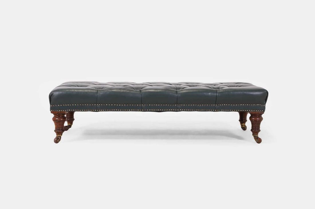 A leather ottoman, 20th century, (1 of 3)