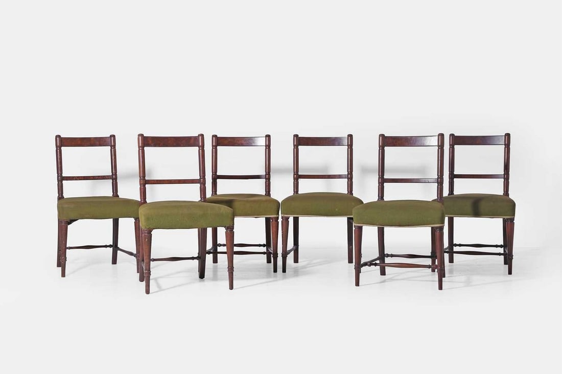 A set of six Regency mahogany dining chairs, early 19th century,: A set of six Regency mahogany dining chairs, early 19th century, each with a bar back and square seat, upholstered in green linen, raised on ring-turned supports (53cm wide, 53cm deep, 87cm high) (6) 