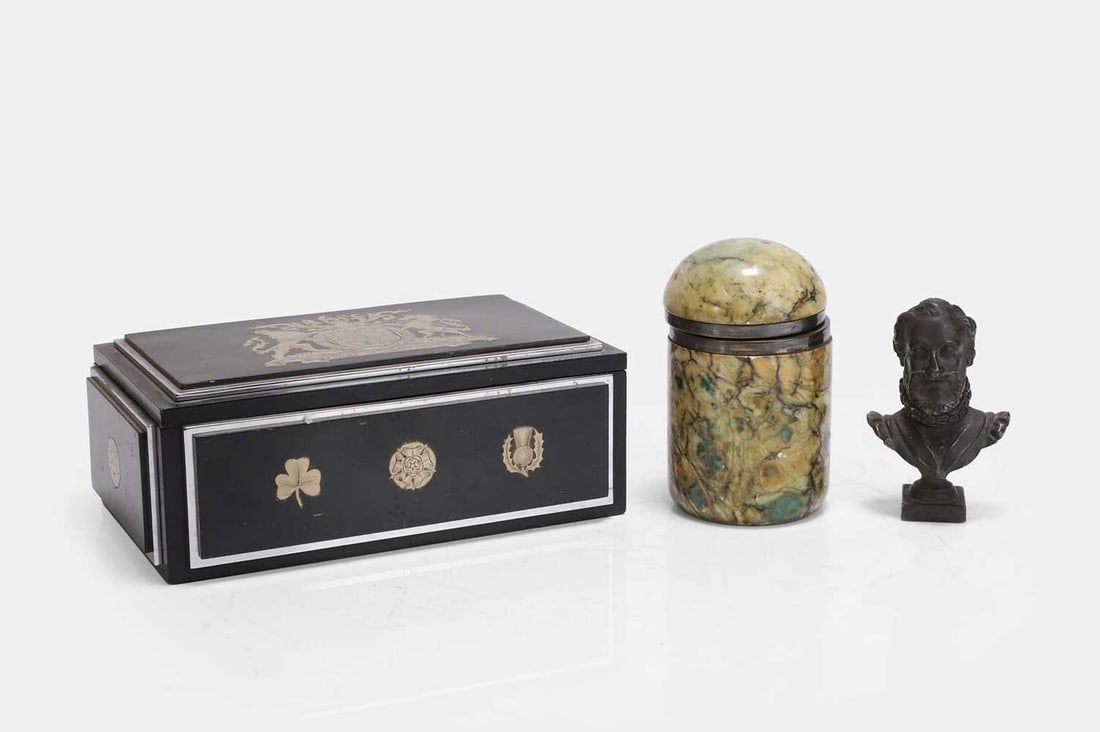 An Art Deco ebonised and silver-plated cigarette box, first quarter of the 20th century,: An Art Deco ebonised and silver-plated cigarette box, first quarter of the 20th century, in the manner of Oscar Callow of Mount Street, the hinged rectangular lid with a marquetry Royal Coat of Arms o