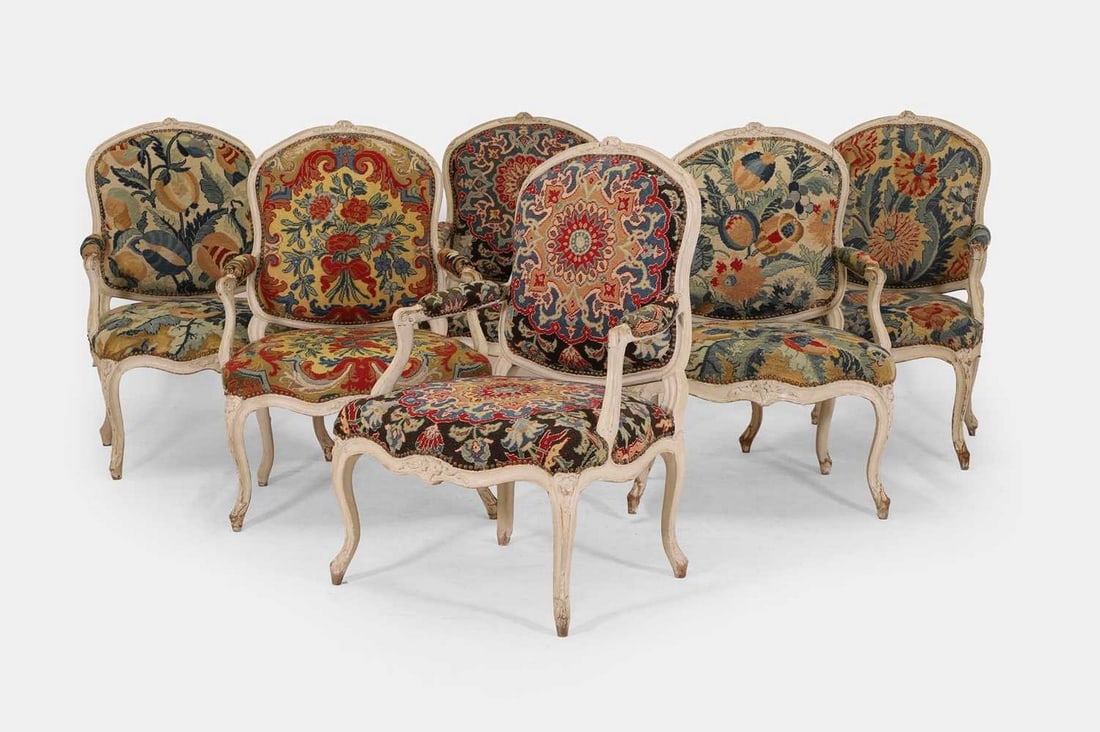 A set of six Louis XV grey painted fauteuils, third quarter of the 18th century, French,: A set of six Louis XV grey painted fauteuils, third quarter of the 18th century, French, covered in floral Lyon needlepoint upholstery, each with a padded cartouche back over a padded stuffover seat f