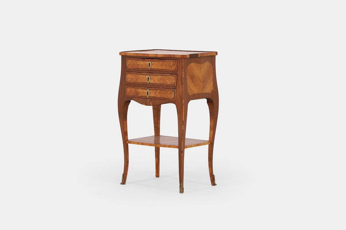 A transitional kingwood, amaranth and tulipwood table en chiffonier, third quarter of the 18th: A transitional kingwood, amaranth and tulipwood table en chiffonier, third quarter of the 18th century, the moulded, crossbanded and quarter-veneered top with floral detail, above three crossbanded sh