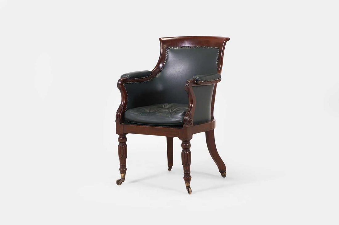 A George IV mahogany library bergère armchair, circa 1830, (1 of 3)