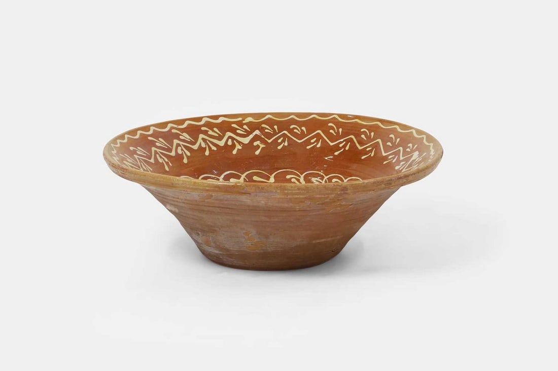 A large slipware bowl, 19th century, probably Spanish, (1 of 3)