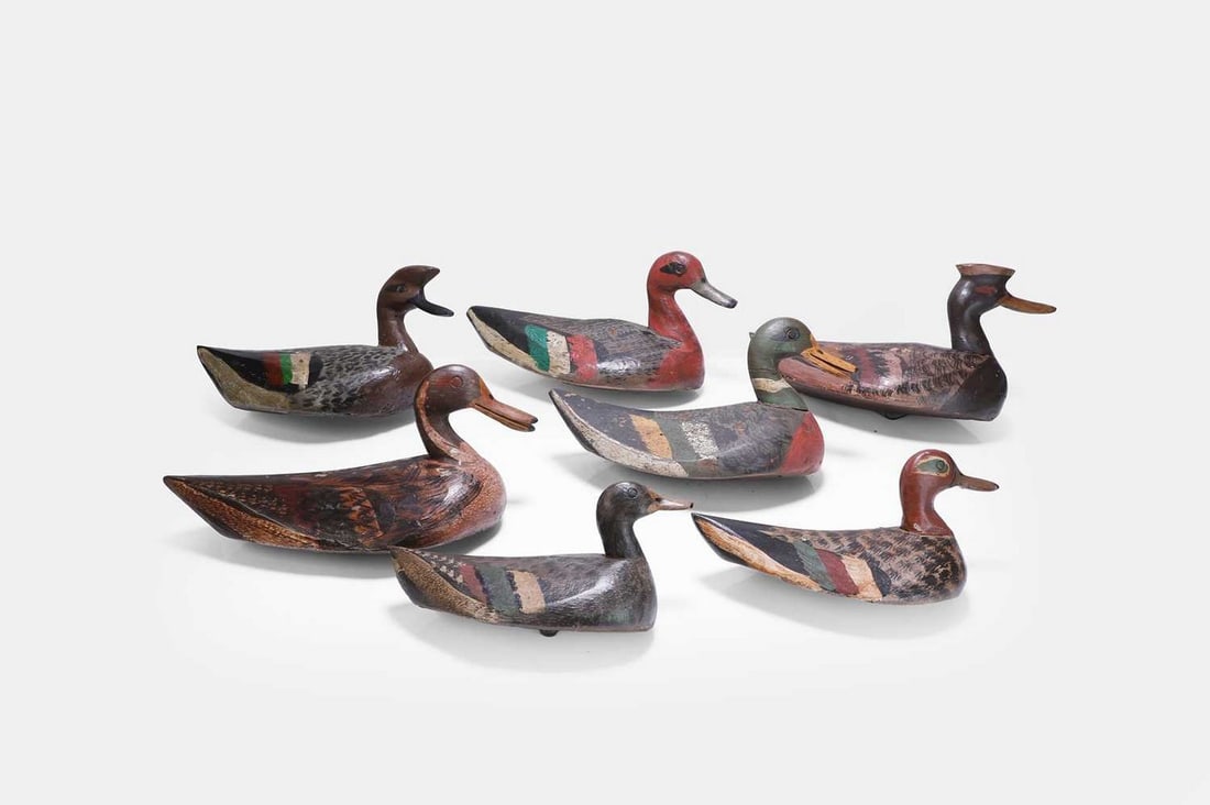 A group of seven decoy ducks, 20th century,: A group of seven decoy ducks, 20th century, of various sizes, all painted in polychrome with impressed marks to base (smallest 26cm wide, 11.5cm deep, 13cm high; largest 38cm wide, 18cm deep, 20cm hig