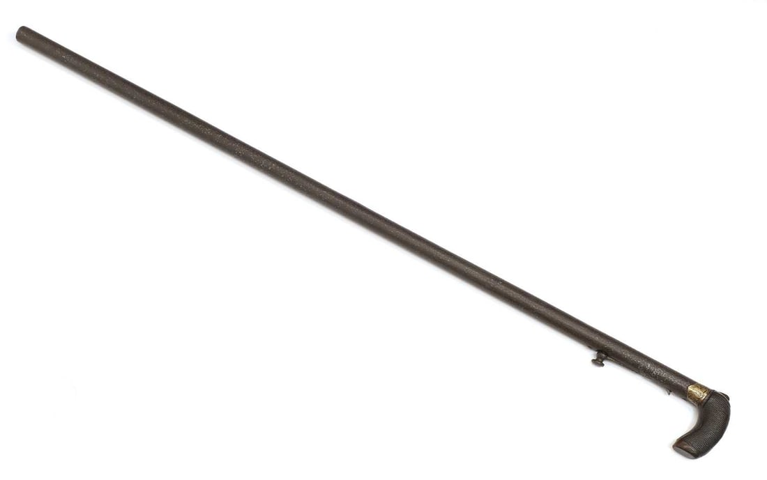 A Patent percussion under hammer walking stick, circa 1900,: A Patent percussion under hammer walking stick, circa 1900, with a latticed carved grip, muzzle loading Shipping Disclaimer: Buyers must be aware of their country’s shipping and import policies