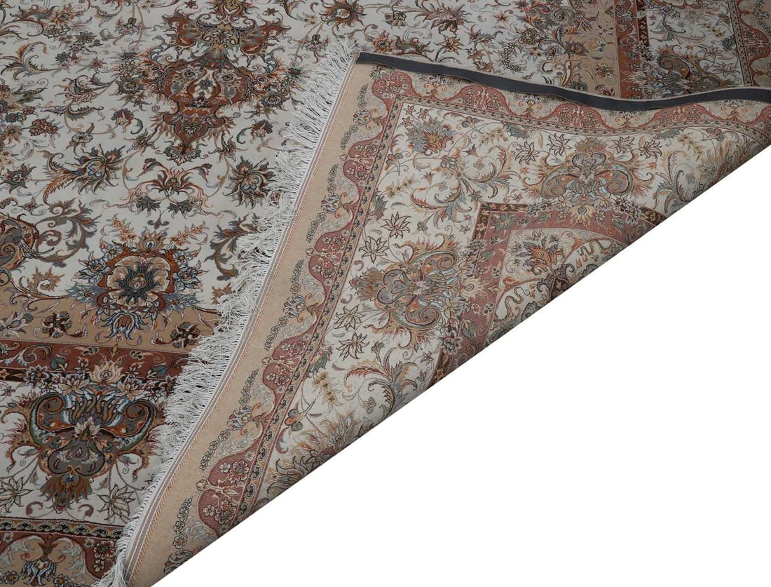A cream ground silk rug, 20th century, - 2