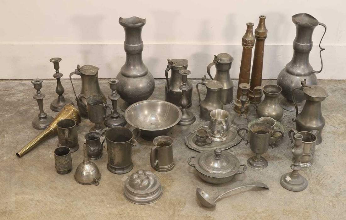 A large quantity of various pewter wares, 18th/19th century and later,: A large quantity of various pewter wares, 18th/19th century and later, to include a large pair of flagons, trophy cups, mugs etc. the largest flagons 47cm high Provenance: The contents of Thornton