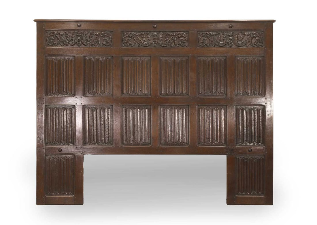 A large linenfold wainscot panel, 16th century / 17th century,: A large linenfold wainscot panel, 16th century / 17th century, with linenfold panels below three carved panels with foliate and cherub design 207cm wide, 159cm high Provenance: The contents of