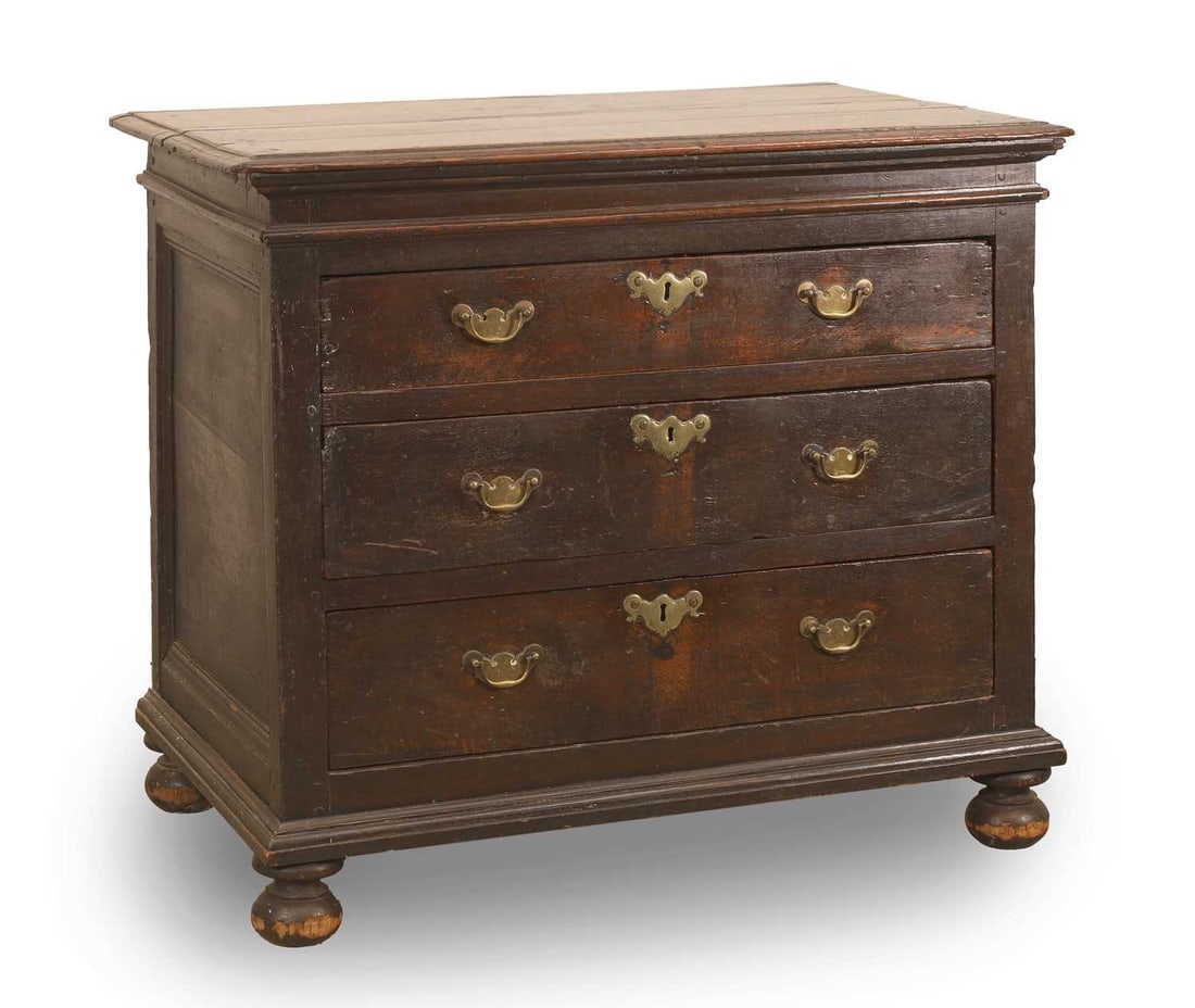 A George I oak chest of three drawers, early 18th century,: A George I oak chest of three drawers, early 18th century, with brass swan neck handles and shaped escutcheons, on bun feet 90cm wide, 57cm deep, 79cm high Provenance: The contents of Thornton House,
