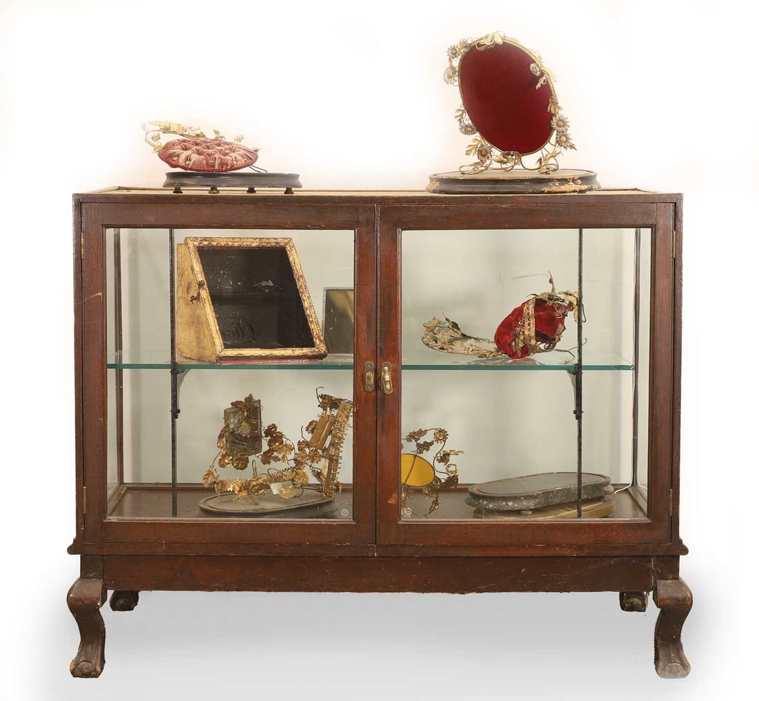 A mahogany framed museum display cabinet circa 1890,: A mahogany framed museum display cabinet circa 1890, the glazed doors with metal shelf supports, and terminating on ball and claw feet, together with a collection French 19th century wedding displays