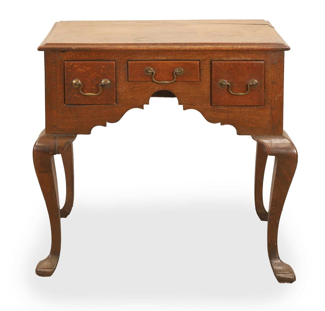 A small oak low boy, 18th century,: A small oak low boy, 18th century, with three short drawers on cabriole legs 69cm wide, 49cm deep, 70cm high Provenance: The contents of Thornton House, Clare.