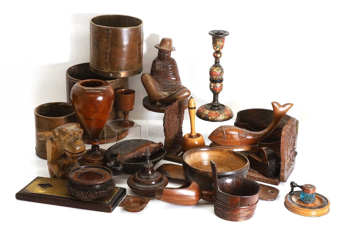 A collection of treen items, 19th century and later,: A collection of treen items, 19th century and later, a turned mahogany urn and cover, a turned mallet, three corn measures, a Kashmiri candlestick, a letter rack, a large novelty monkey nutcracker, a