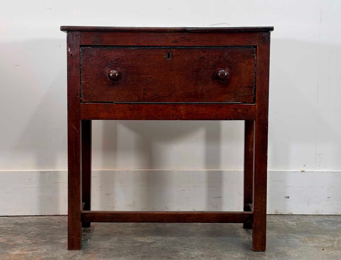A small oak dresser base, 18th century,: A small oak dresser base, 18th century, with a single drawer with turned handles, the legs united by stretchers 79cm wide, 40cm deep, 85cm high Provenance: The contents of Thornton House, Clare.