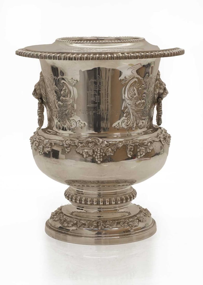 An Elizabeth II silver wine cooler, Garrard and Co., London, 1973: An Elizabeth II silver wine cooler, Garrard and Co., London, 1973 with silver liner, decorated with cast with fruiting vines and chased and engraved decoration, with cast lion's mask ring handles to
