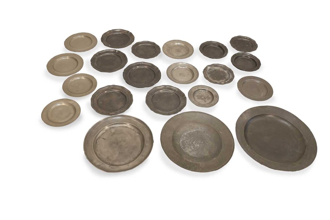 A large quantity of pewter chargers and plates, 18th century and later,: A large quantity of pewter chargers and plates, 18th century and later, to include a set of petal-edged plates the largest 46cm diameter