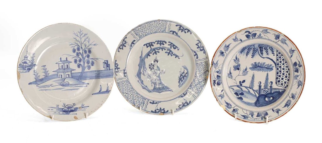 Three English Delft plates, mid 18th century,: Three English Delft plates, mid 18th century, each with chinoiserie scenes and figures, 22.5cm and 22cm diameter 3 Condition Report: #1 various chips to the rim, nibbles and losses #2 chips to the