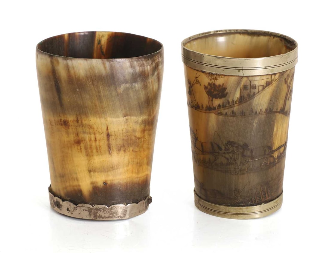 Two horn beakers, early 19th century,: Two horn beakers, early 19th century, one engraved with a farming scene, mounted with a plated rim and base, the other plain with a base rim mount 10.8cm and 10.5cm high 2 Condition Report: Both with