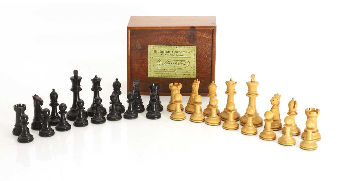 A J Jaques and Son 'The Staunton Chessmen' pattern chess set, early 20th century,: A J Jaques and Son 'The Staunton Chessmen' pattern chess set, early 20th century, each weighted boxwood and ebonised playing pieces, one knight and a rook from each set marked, in a felt-lined
