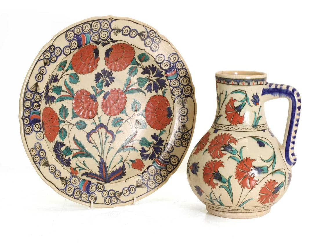 A Isnik style plate, circa 2000, Morocco,: A Isnik style plate, circa 2000, Morocco, together with a similar jug, both with floral decoration and inscribed to the reverse 'MELINAC OSKUN TUNA BURSA -2001' and 'MELIHA COSKUN TUNA SERAMIK BURSA