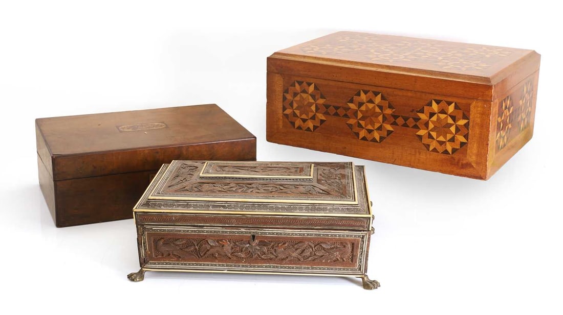 An Anglo-Indian Vizagapatam carved wood, sadeli and ivory mounted casket, late 19th century,: An Anglo-Indian Vizagapatam carved wood, sadeli and ivory mounted casket, late 19th century, with a plain interior, with purple felt, with brass claw feet, a Tunbridgeware inlaid walnut writing slope,