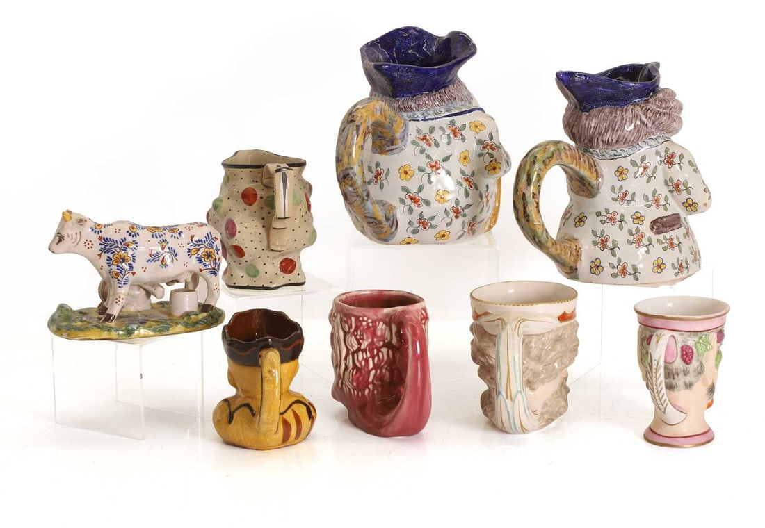 Five pottery and bone china 'Mask' jugs, 19th century and later, - 2