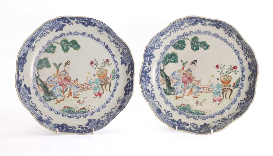 A pair of Chinese famille rose dishes, 18th century,: A pair of Chinese famille rose dishes, 18th century, each of lobed form, painted to the centre with a lady and a boy in a garden 26cm diameter 2