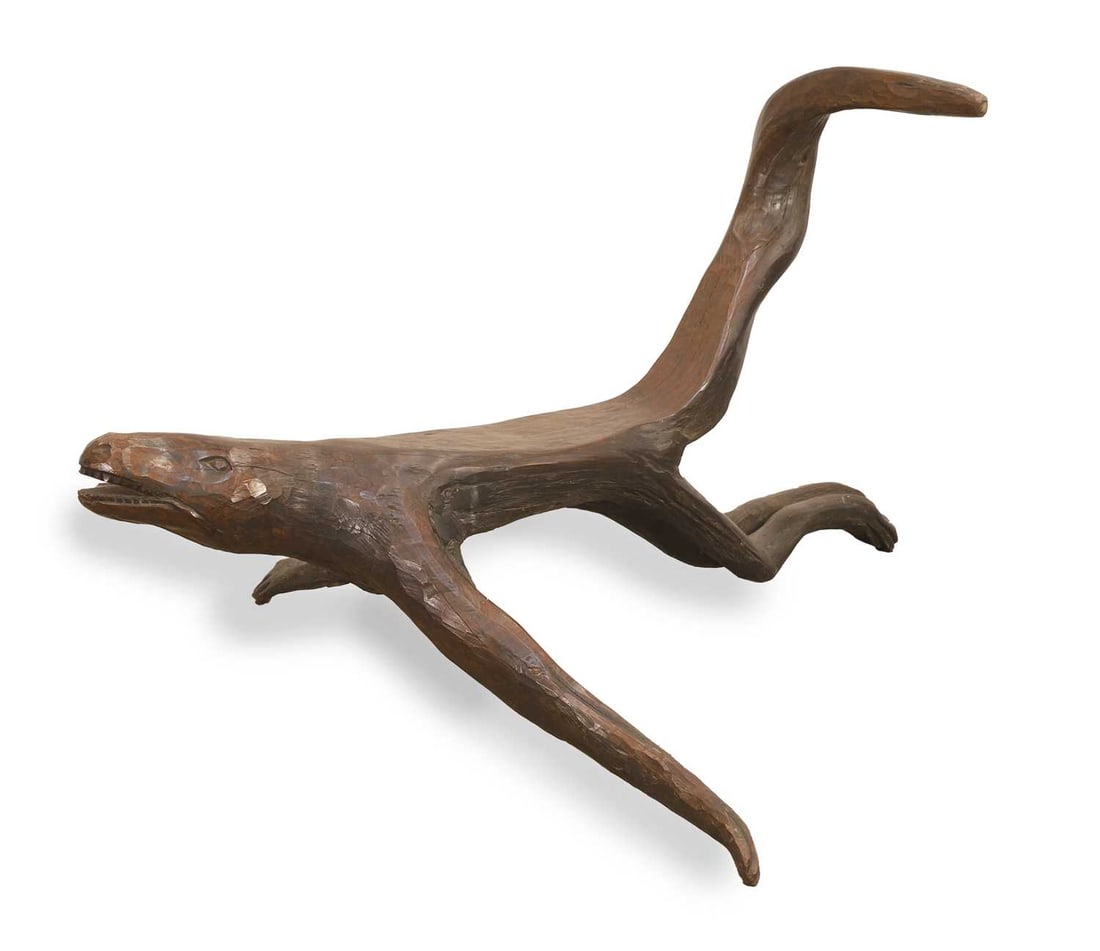 An African carved dragon stool,: An African carved dragon stool, in naive style, the tail carved into a backsplat 90cm wide, 115cm deep, 60cm high Condition Report: Splits to the underside