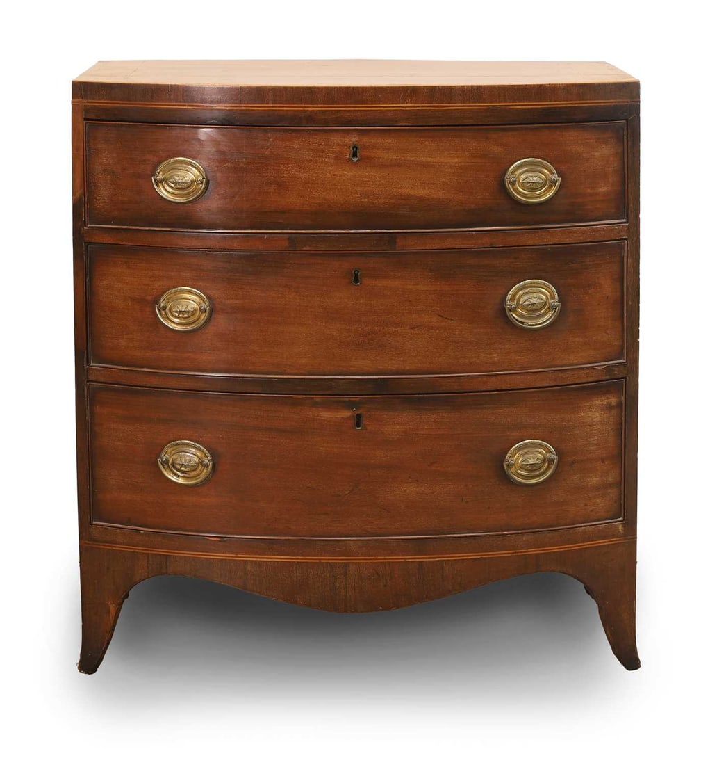 A mahogany bow fronted chest of drawers, early 19th century, (1 of 2)