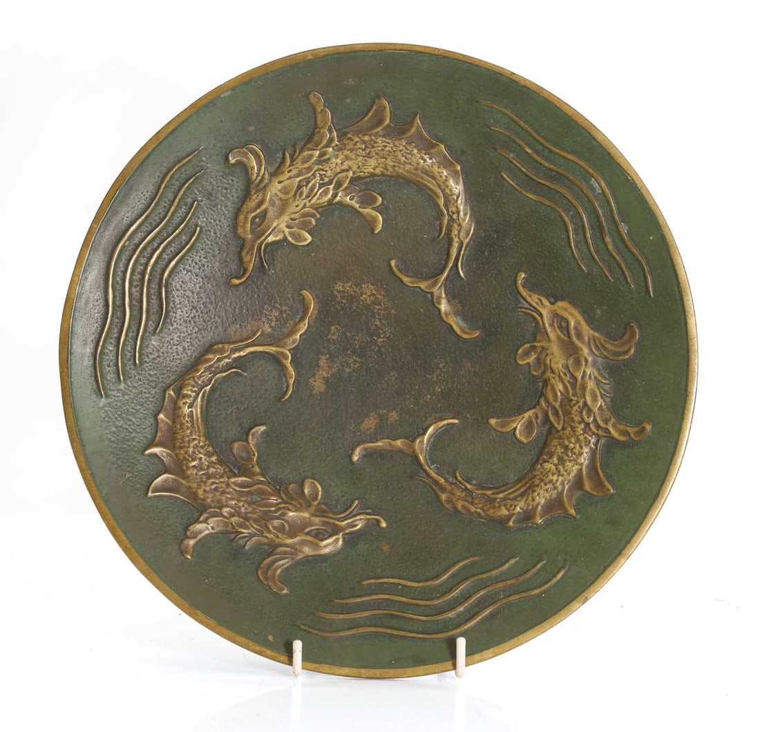 Max Le Verrier (French,1891-1973) a green patinated bronze dish, circa 1930,: Max Le Verrier (French,1891-1973) a green patinated bronze dish, circa 1930, cast with sea creatures and stylised waves, on three screw lugs, with a ring suspension, cast and stamped marks 28cm